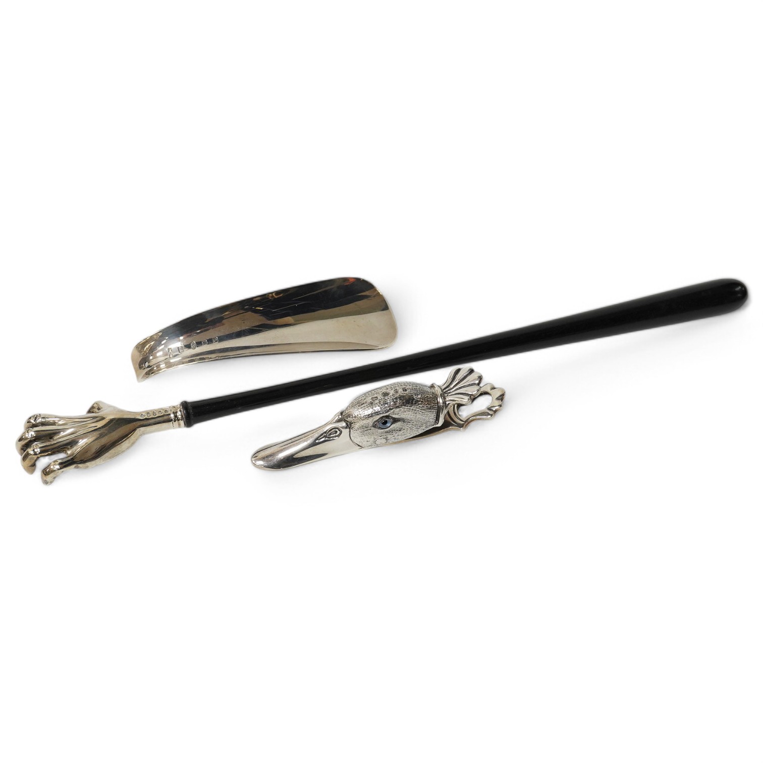 A modern novelty ebony handled silver back scratcher, 	Francis Howard Ltd, London, 2008, 38.6cm, a modern silver novelty duck’s head combination paperclip/match strike, London, 1905 and a silver shoe-horn. Condition - fa